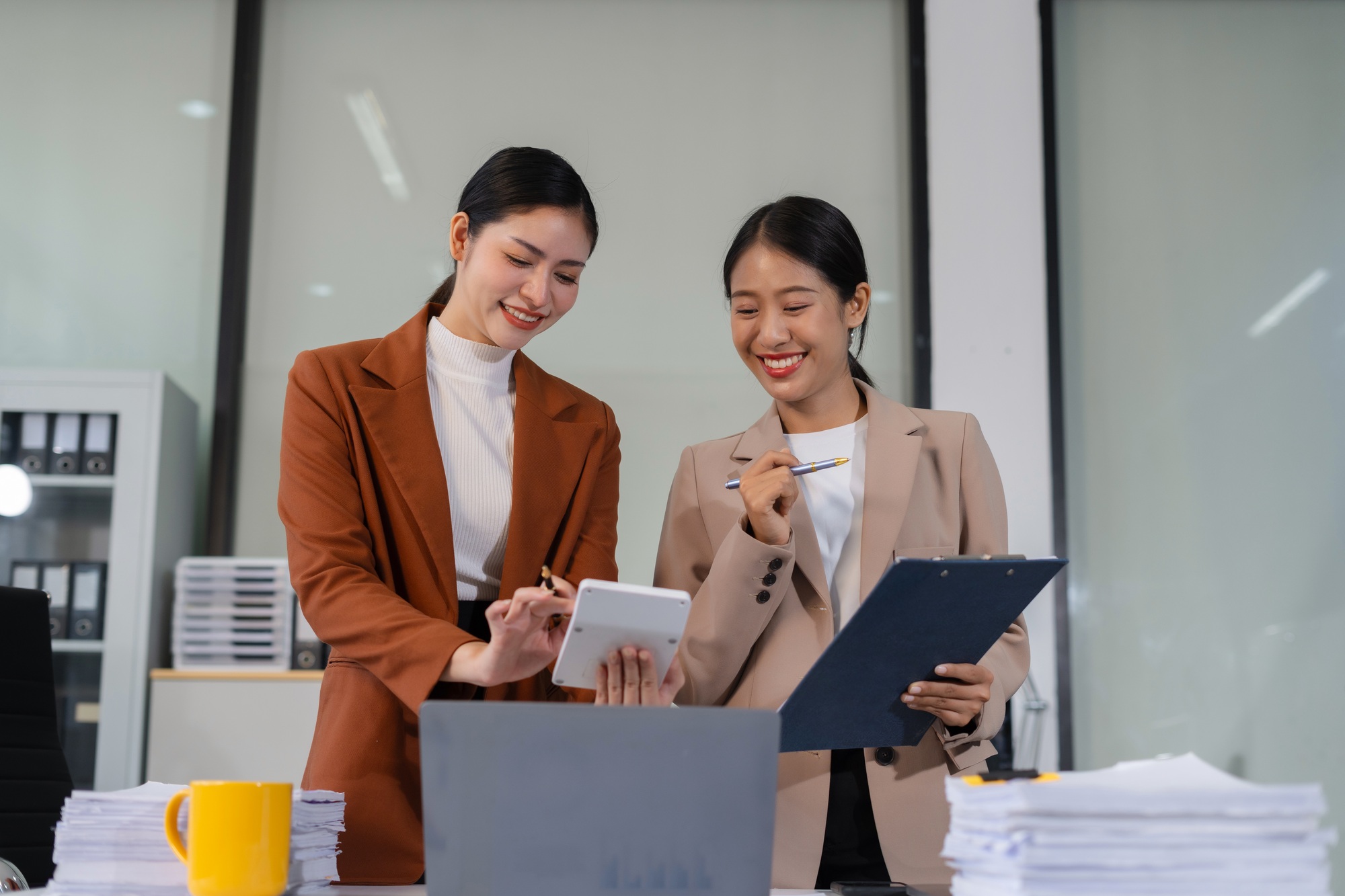 Team of businesswomen analyzing financial charts, planning company growth.
